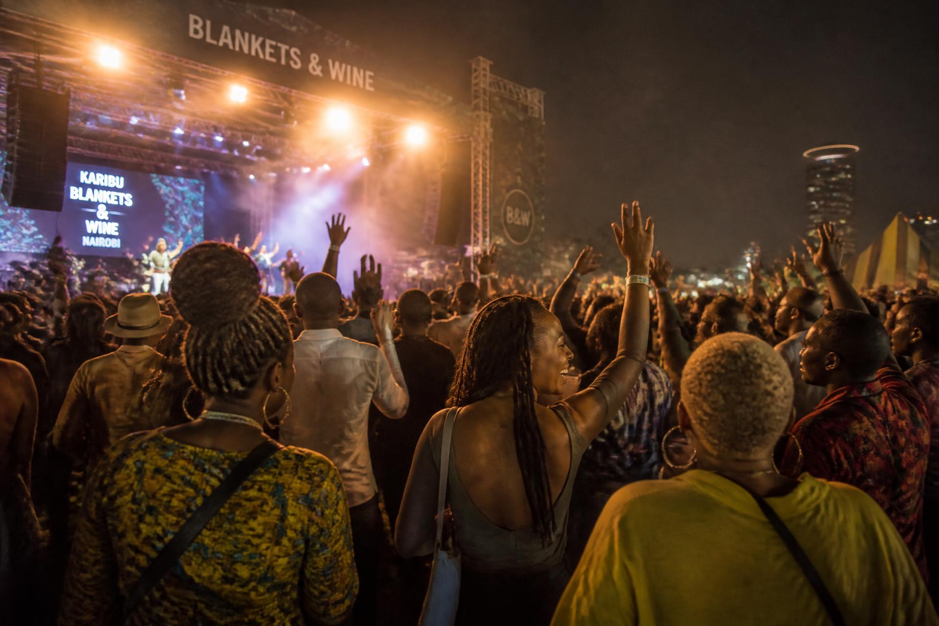 Live music festival crowd under stage lights